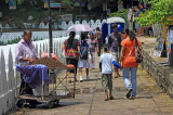 SRI LANKA, Kandy, Kandy lakeside, people walking along promenade, SLK3953JPL