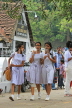 SRI LANKA, Kandy, Kandy lakeside, school children walking along the promenade, SLK3939JPL