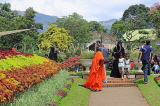 SRI LANKA, Kandy, Peradeniya Botanical Gardens, Flower Garden, visitors and monk, SLK4919JPL