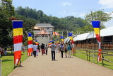SRI LANKA, Kandy, Temple of the Tooth (Dalada Maligawa), visitors and Buddhist flags on walkway, SLK3346JPL