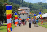SRI LANKA, Kandy, Temple of the Tooth (Dalada Maligawa), visitors and Buddhist flags on walkway, SLK3347JPL
