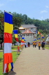 SRI LANKA, Kandy, Temple of the Tooth (Dalada Maligawa), visitors and Buddhist flags on walkway, SLK3348JPL
