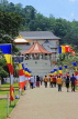 SRI LANKA, Kandy, Temple of the Tooth (Dalada Maligawa), visitors and Buddhist flags on walkway, SLK3349JPL