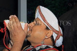 SRI LANKA, Kandy, cultural show, man blowing conch shell, SLK5071JPL
