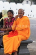 SRI LANKA, Kandy, woman Buddhist Monk, enjoying Ice Lolly, SLK3930JPL