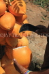 SRI LANKA, Kandy area, roadside stall selling King Coconut (Thambili), vendor cutting fruit, SLK2559JPL