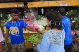 SRI LANKA, Kelaniya Temple (near Colombo), flower offerings, woman at stall, SLK5464JPL