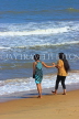 SRI LANKA, Negombo, beach, and two women paddling, SLK6328JPL