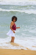 SRI LANKA, Negombo, beach and sea, Sri Lankan woman enjoying paddling, SLK2589JPL