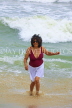 SRI LANKA, Negombo, beach and sea, Sri Lankan woman enjoying paddling, SLK2591JPL