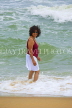 SRI LANKA, Negombo, beach and sea, Sri Lankan woman enjoying paddling, SLK2736JPL