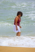 SRI LANKA, Negombo, beach and sea, Sri Lankan woman enjoying paddling, SLK2737JPL