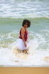 SRI LANKA, Negombo, beach and sea, Sri Lankan woman enjoying paddling, SLK2738JPL