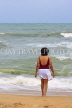 SRI LANKA, Negombo, beach and sea, Sri Lankan woman paddling, SLK2588JPL
