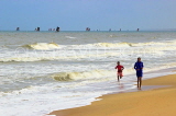 SRI LANKA, Negombo, beach and sea, boys running along beach, SLK3561JPL