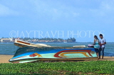 SRI LANKA, Negombo, beach with upturned boat, and couple, SLK6133JPL