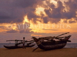 SRI LANKA, Negombo, dusk, catamaran and boy on beach, SLK268JPL