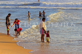 SRI LANKA, Negombo, evening by the seaside, people enjoying paddling, SLK5944JPL