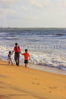 SRI LANKA, Negombo, family paddling, walking along beach, SLK3532JPL