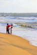 SRI LANKA, Negombo, family paddling along beach, SLK3533JPL