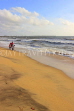 SRI LANKA, Negombo, family walking along beach, SLK3534JPL
