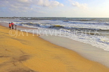 SRI LANKA, Negombo, family walking along beach, SLK3535JPL
