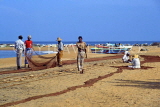 SRI LANKA, Negombo, fishermen sorting out nets on beach, SLK1719JPL