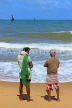 SRI LANKA, Negombo, fishing village, seaside, and two fishermen on beach, SLK6044JPL