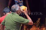 SRI LANKA, Negombo, man drinking King Coconut (Thambili) water, SLK6108JPL