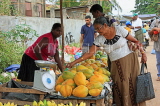 SRI LANKA, Negombo, market, fruit and vegetable market, Papaya stall, vendor and shopper, SK2728JPL