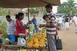 SRI LANKA, Negombo, market, fruit and vegetable market, Papaya stall, vendor and shopper, SK2731JPL