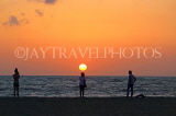 SRI LANKA, Negombo, sea and sun setting over horizon, people watching sunset, SLK3526JPL