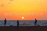 SRI LANKA, Negombo, sea and sun setting over horizon, people watching sunset, SLK3527JPL