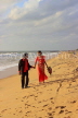 SRI LANKA, Negombo, wedding couple walking along beach, SLK3528JPL