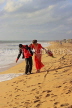 SRI LANKA, Negombo, wedding couple walking along beach, SLK3529JPL