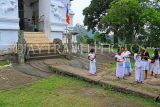 SRI LANKA, Pilimathalawa (nr Kandy), Lankatilaka Vihare, worshippers with flower offerings, SLK4134JPL