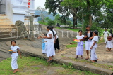 SRI LANKA, Pilimathalawa (nr Kandy), Lankatilaka Vihare, worshippers with flower offerings, SLK4135JPL