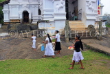SRI LANKA, Pilimathalawa (nr Kandy), Lankatilaka Vihare, worshippers with flower offerings, SLK4137JPL
