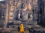 SRI LANKA, Polonnaruwa, Gal Viahre (stone temple), granite carved seated Buddha, and monk, SLK100JPL