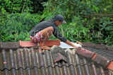 SRI LANKA, Pussellawa, man repairing roof tiles, SLK4170JPL