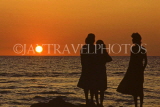 SRI LANKA, south coast, Gintota, people silhouetted against sunset, SLK1670JPL