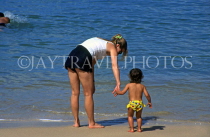 ST LUCIA, Marigot Bay, tourist and child, on beach, STL646JPL