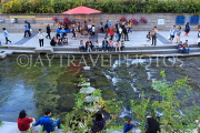 South Korea, SEOUL, Cheonggyecheon Stream, people relaxing by the banks, SK734JPL