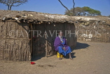 TANZANIA, Serengeti National Park, Massai Mara woman in front of her home, TAN839JPL