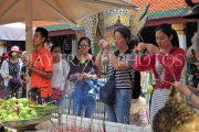 THAILAND, Bangkok, GRAND PALACE (Wat Phra Keo), worshippers at a shrine, THA2486JPL