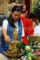 THAILAND, Bangkok, GRAND PALACE, worshipper bathing Buddha image, Songkran (New Year), THA12JPL