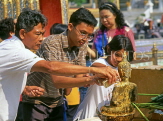 THAILAND, Bangkok, GRAND PALACE, worshippers bathing Buddha image, Songkran (New Year), THA729JPL