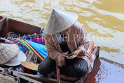 THAILAND, Damnoen Saduak (Floating Market), vendor with mobile phone, THA2977JPL