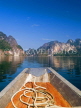 THAILAND, Khao Sok National Park, karst peaks reflected in Chao Lan Lake and boat, THAJPL