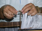 THAILAND, Korat, worker's hands weaving silk on loom, THA2098JPL